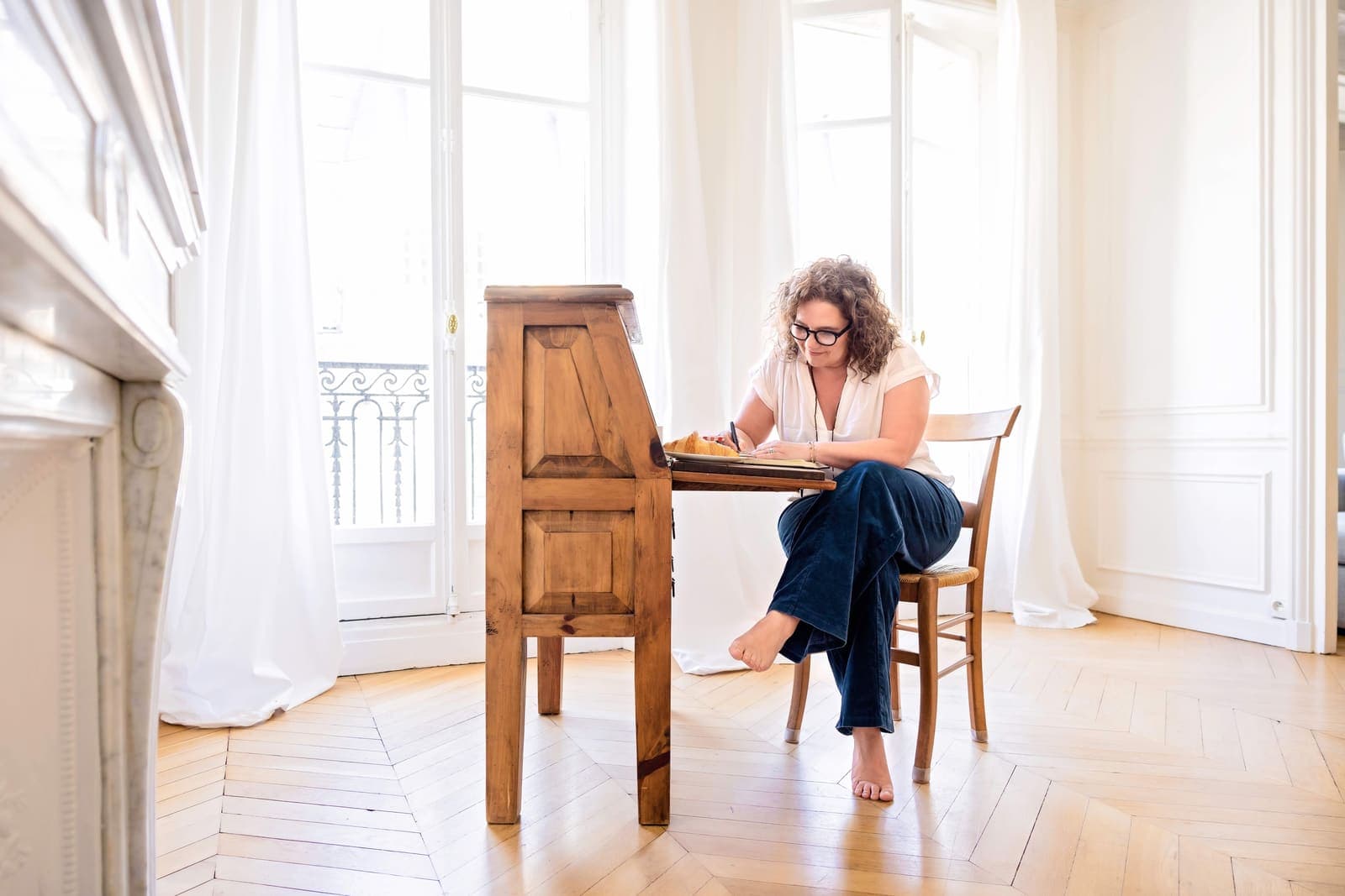 Mieke painting at her desk