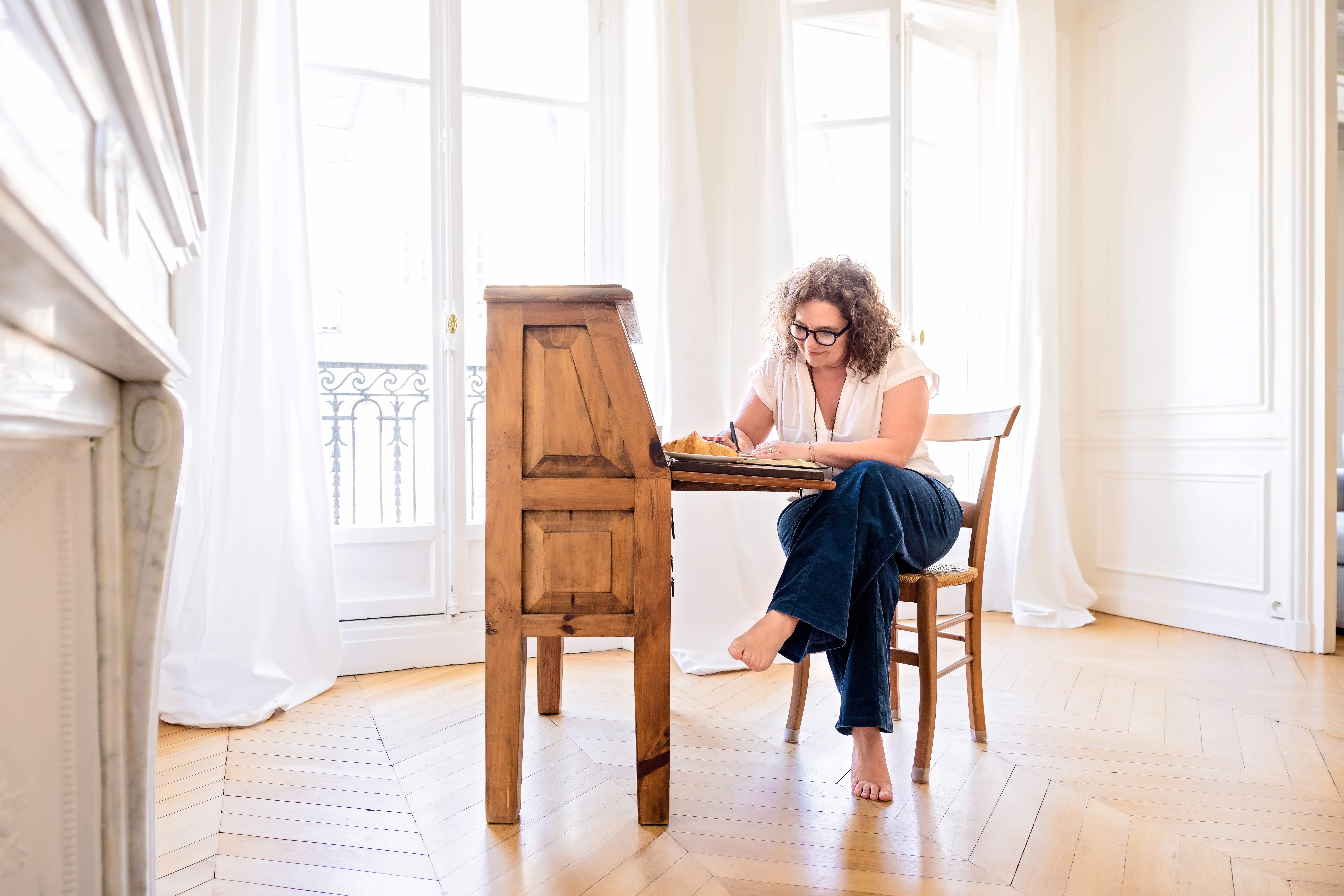 Mieke painting at her desk